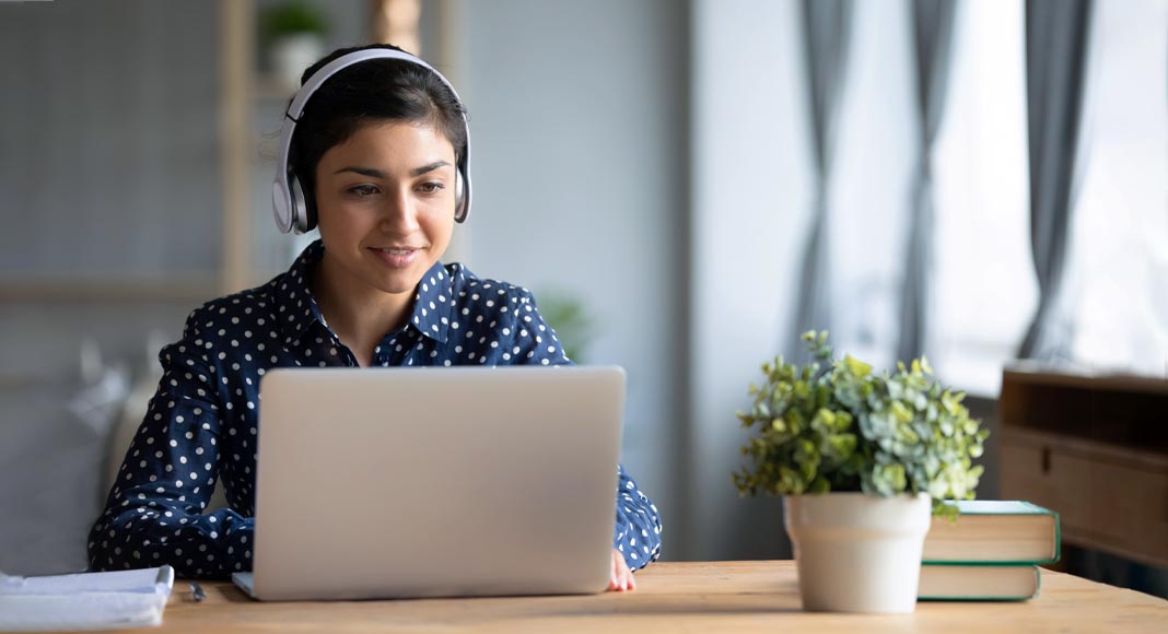 Happy female radio host broadcasting in a flat